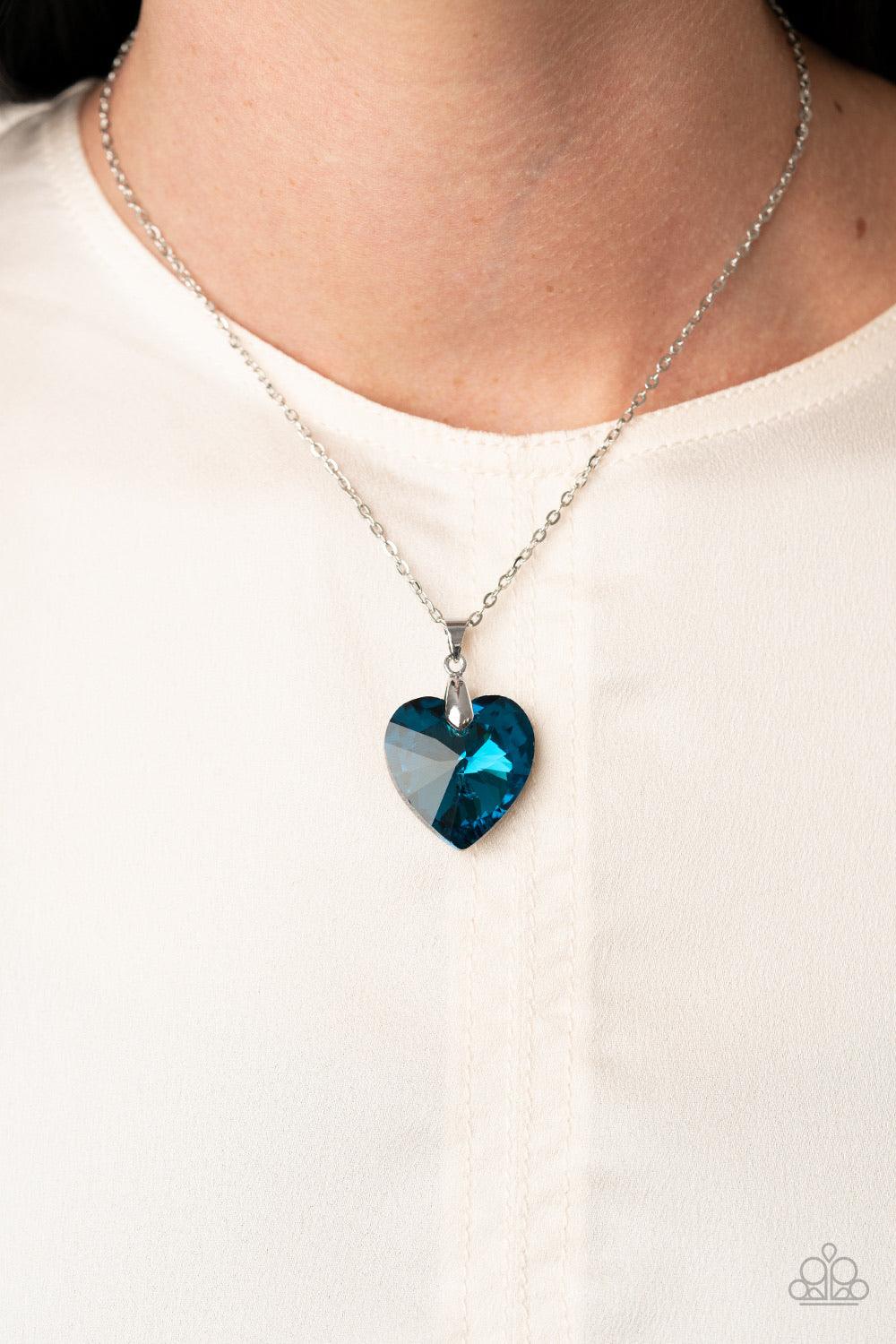 Paparazzi Accessories Love Hurts - Blue Chiseled into a charming heart, an oversized blue gem slides along a dainty silver chain below the collar for a flirtatious finish. Features an adjustable clasp closure. Sold as one individual necklace. Includes one