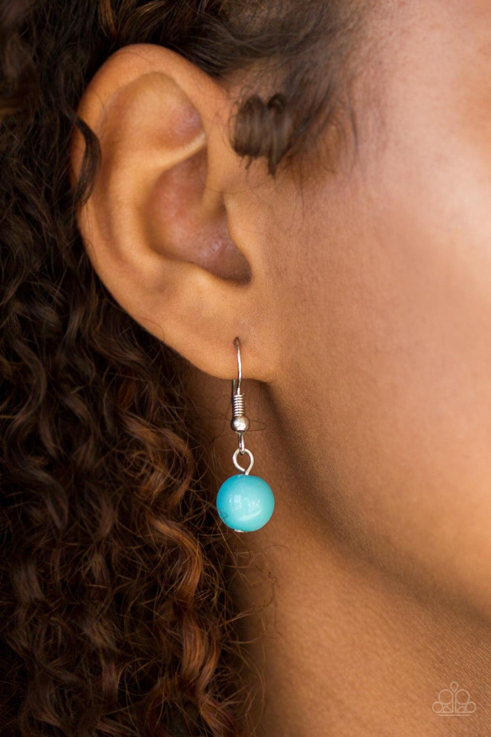 Paparazzi Accessories Hitting a GLOW Point - Blue Featuring faceted silver accents, glassy and polished blue beads trickle along strands of shimmery silver chains for a seasonal look. Features an adjustable clasp closure. Sold as one individual necklace.
