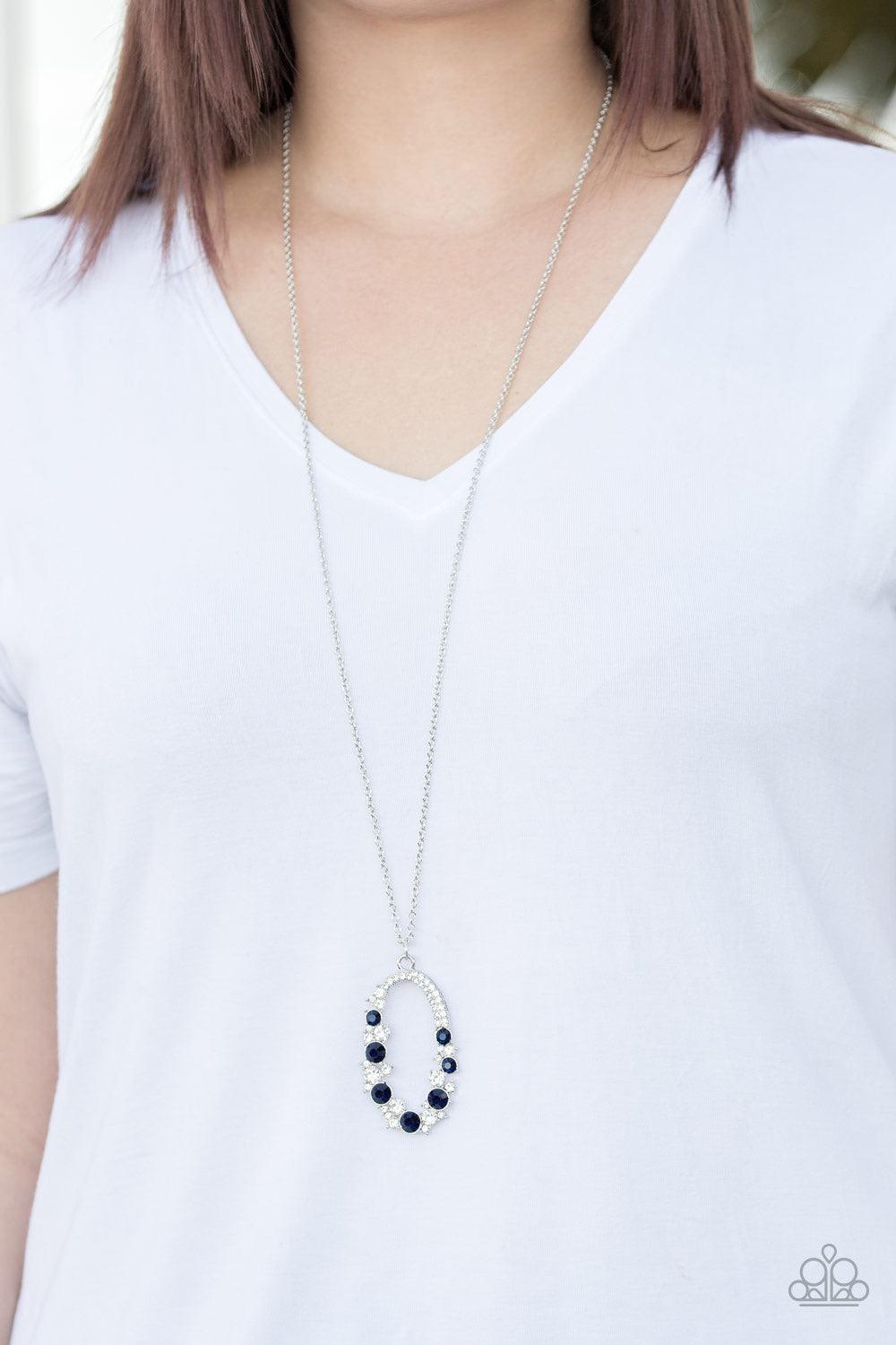 Paparazzi Accessories Spotlight Social - Blue Varying in size, an array of glittery white and blue rhinestones are encrusted along a shimmery silver hoop. The sparkling pendant swings from the bottom of an elongated silver chain for a glamorous finish. Fe