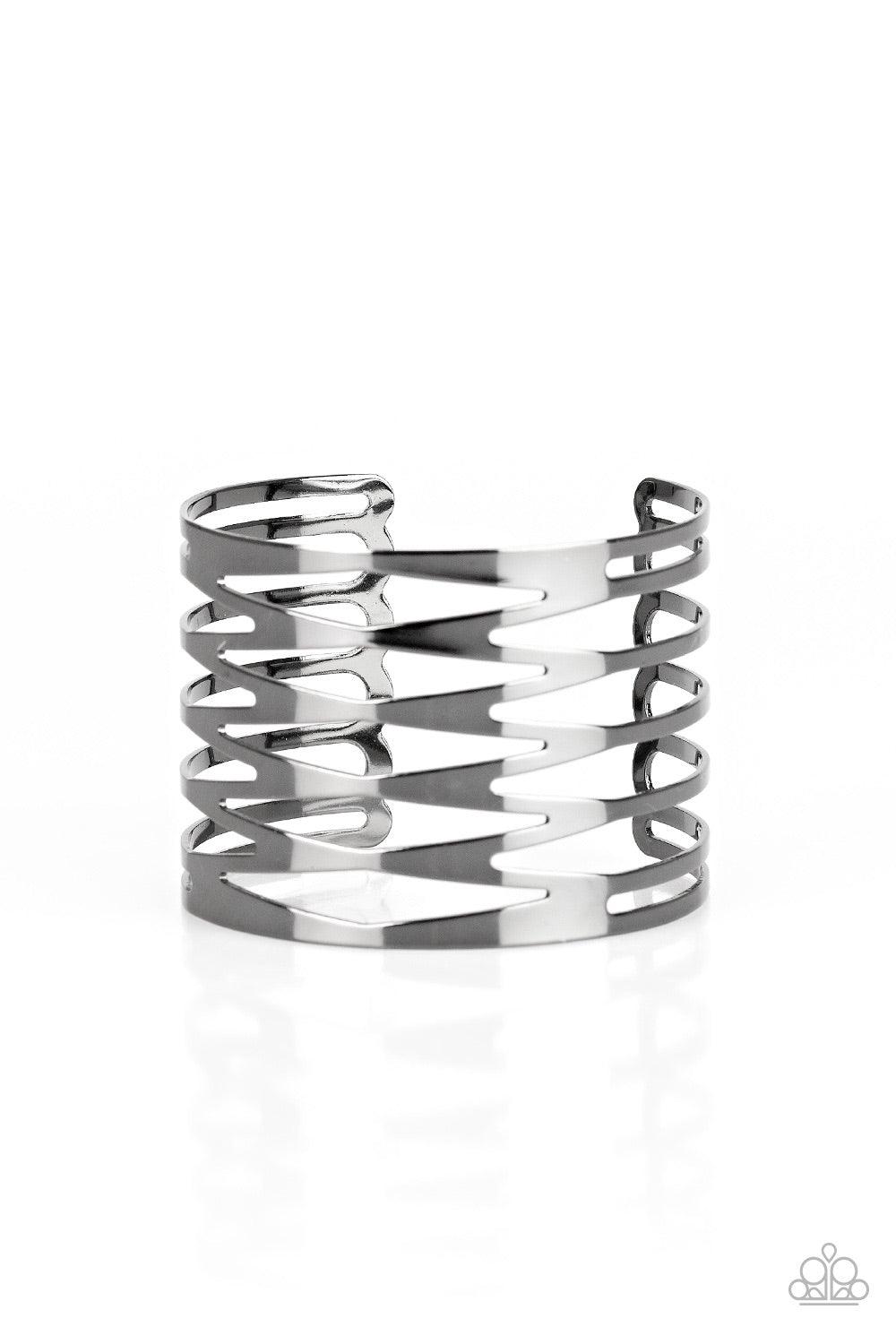 Paparazzi Accessories Keep Them On Edge - Black Brushed in a high-sheen finish, flat gunmetal bars race back and forth across the wrist, coalescing into an edgy cuff. Jewelry