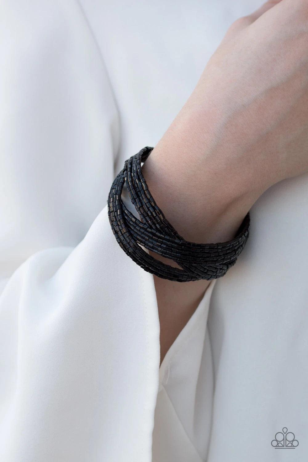 Paparazzi Accessories Shooting Star ~Black Layers of shiny black seed beads are braided together to create a breathtaking cuff design that shimmers brilliantly along the wrist.