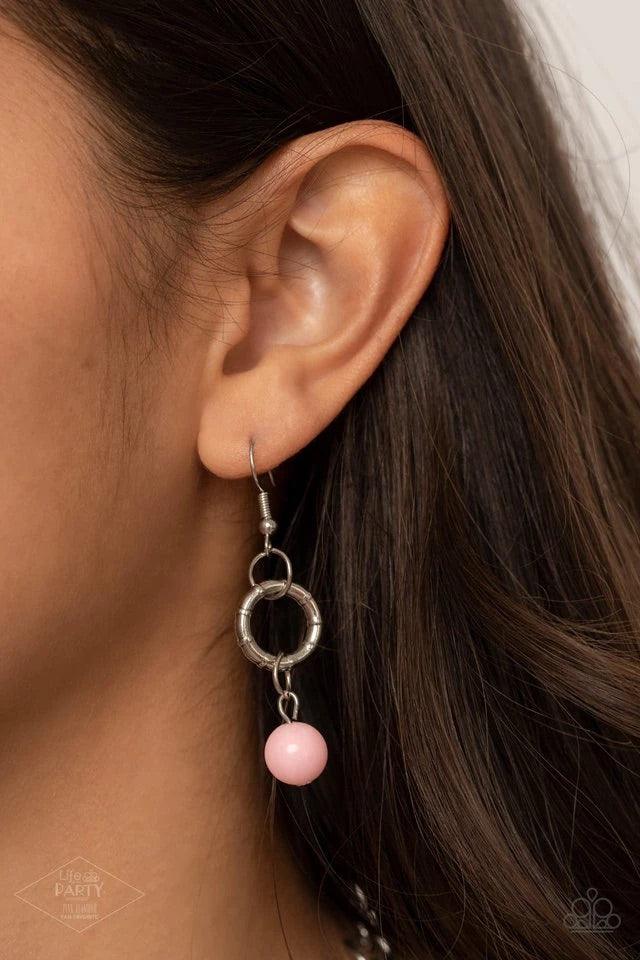 Paparazzi Accessories Charmed, I Am Sure - Pink Pink cording is braided through a chunky silver chain. A unique variety of charms decorate the piece including a delicate flower and a heart inscribed with the phrase "With All My Heart" on one side and a sh