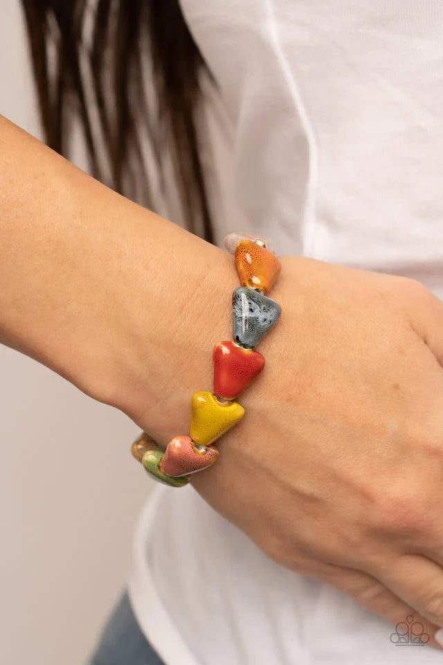 Paparazzi Accessories SHARK Out of Water - Multi Our SHARK Out of Water statement piece is a must-have for any spring/summer wardrobe! Painted in distressed multicolored finishes, ceramic beads shaped like shark teeth are threaded along a stretchy band ar
