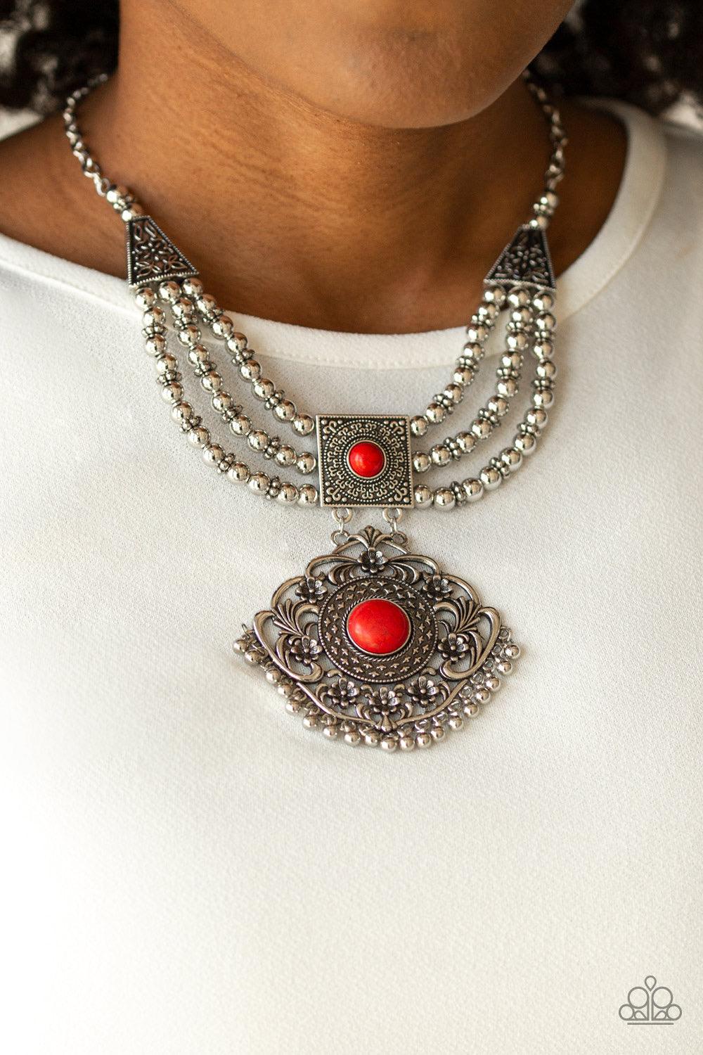Paparazzi Accessories Santa Fe Solstice - Red Dotted with fiery red stone centers, two ornate frames link below the collar. Strands of silver beads are threaded through the uppermost pendant, adding an antiqued flair to the tribal inspired pendant. Featur