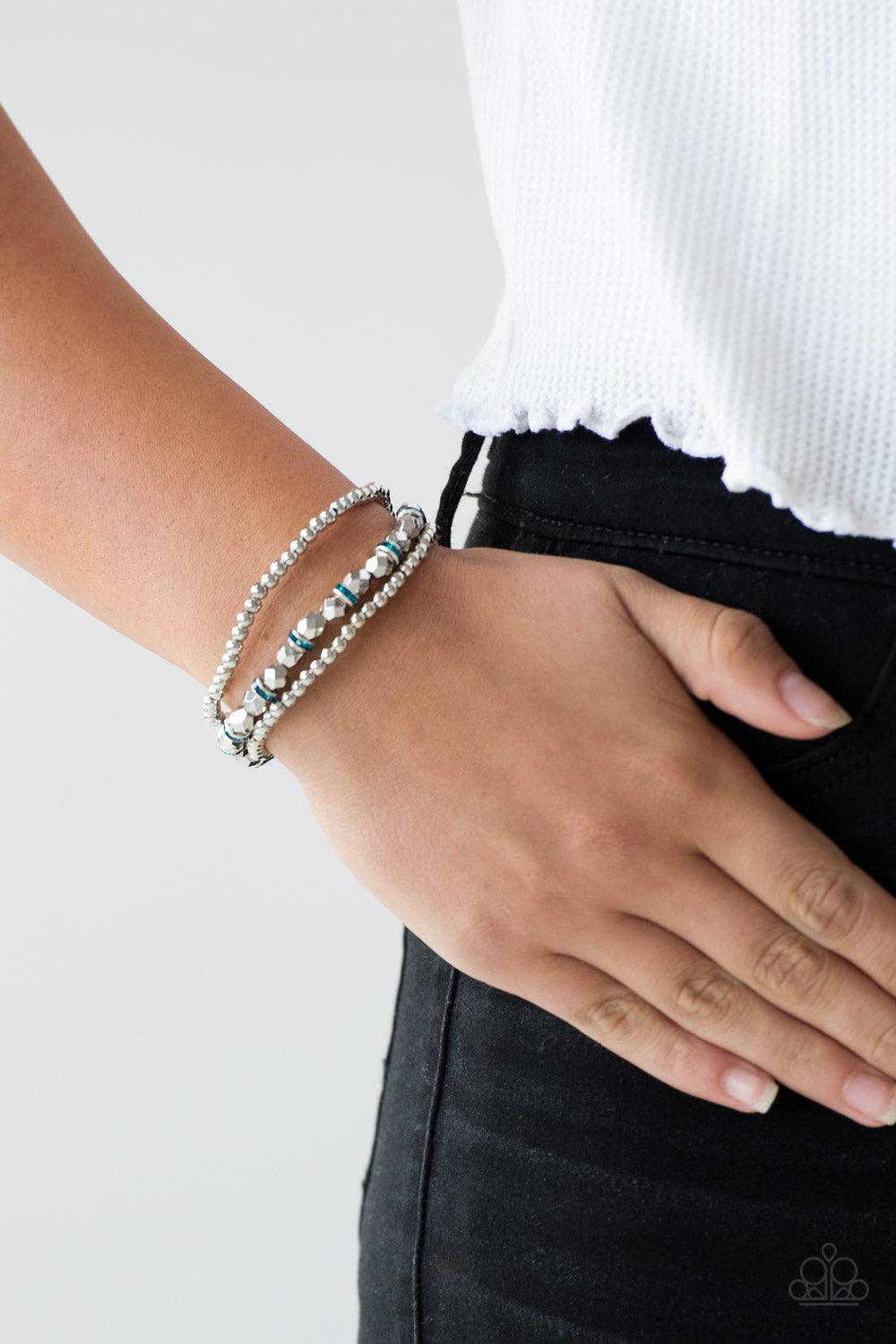 Paparazzi Accessories Let There BEAM Light - Blue Infused with blue rhinestone encrusted rings, mismatched dainty silver and faceted silver beads are threaded along stretchy bands for a refined look. Jewelry