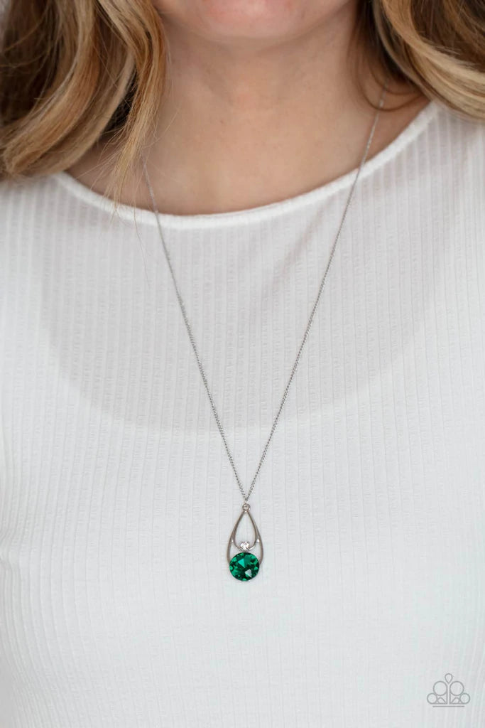 Paparazzi Accessories Gala Gleam - Green Two silver teardrops delicately overlap in a solitaire pendant at the bottom of a shiny silver chain. A dainty white rhinestone dots the bottom of the highest teardrop, while an oversized green gem adorns the lower