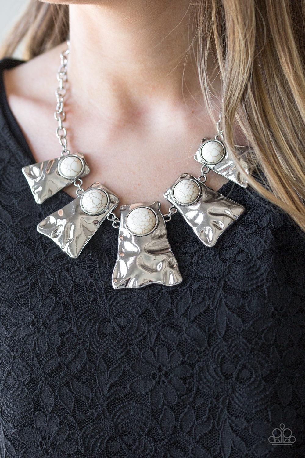 Paparazzi Accessories Cougar - White Rippling with hammered details, flared silver frames join below the collar, creating a fierce fringe. Refreshing white stones are pressed into the tops of the frames for a colorful finish. Features an adjustable clasp