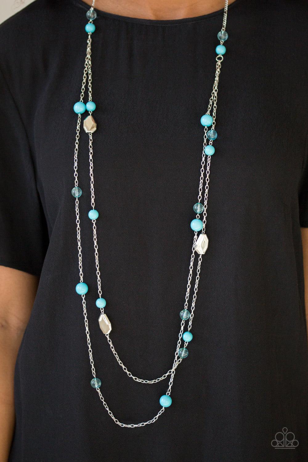 Paparazzi Accessories Hitting a GLOW Point - Blue Featuring faceted silver accents, glassy and polished blue beads trickle along strands of shimmery silver chains for a seasonal look. Features an adjustable clasp closure. Sold as one individual necklace.
