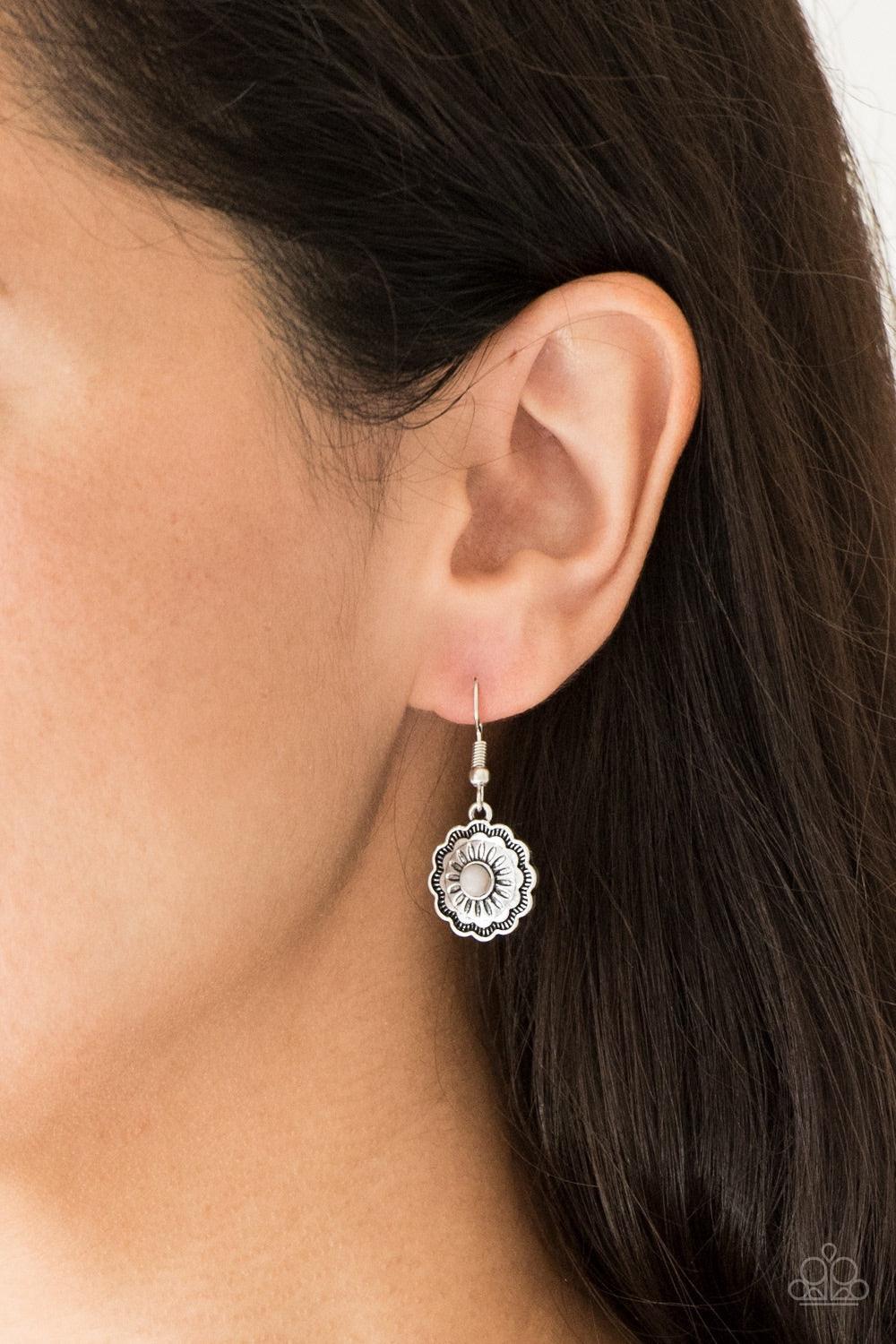 Paparazzi Accessories Badlands Buttercup - Silver A gray stone is pressed into a shimmery silver floral frame radiating with antiqued textures for a seasonal flair. Earring attaches to a standard fishhook fitting. Jewelry