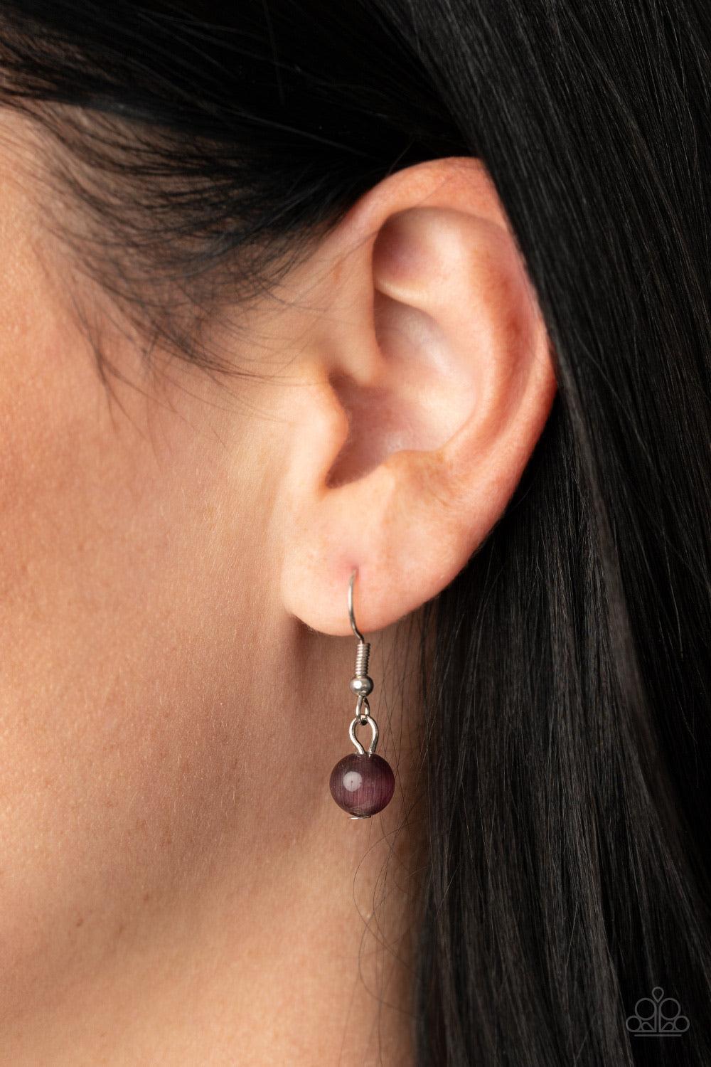 Paparazzi Accessories Ethereal Escape - Purple Featuring sleek silver fittings, a collection of round purple cat's eye stone pendants link below the collar for a colorfully ethereal look. Features an adjustable clasp closure. Sold as one individual neckla