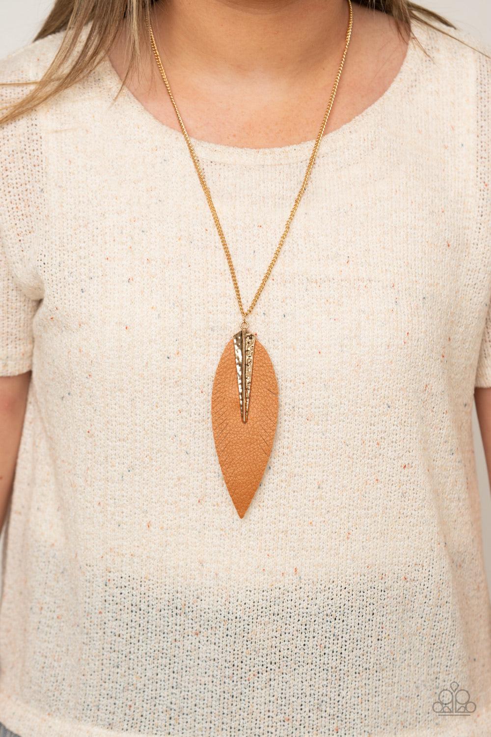 Paparazzi Accessories Quill Quest - Gold Pinched between a hammered gold fitting, a leaf shaped brown leather frame is spliced into feathery detail at the bottom of a lengthened gold chain for a free-spirited look. Features an adjustable clasp closure. So