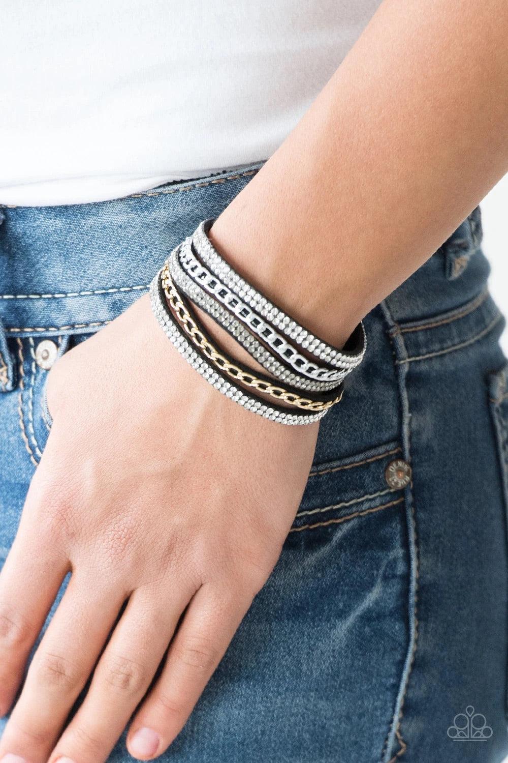 Paparazzi Accessories Fashion Fiend - Black Glassy white and smoky rhinestones are encrusted along strands of black suede. Glistening silver and gold chains are added to the bands, adding edgy industrial shimmer to the sassy palette. Features an adjustabl