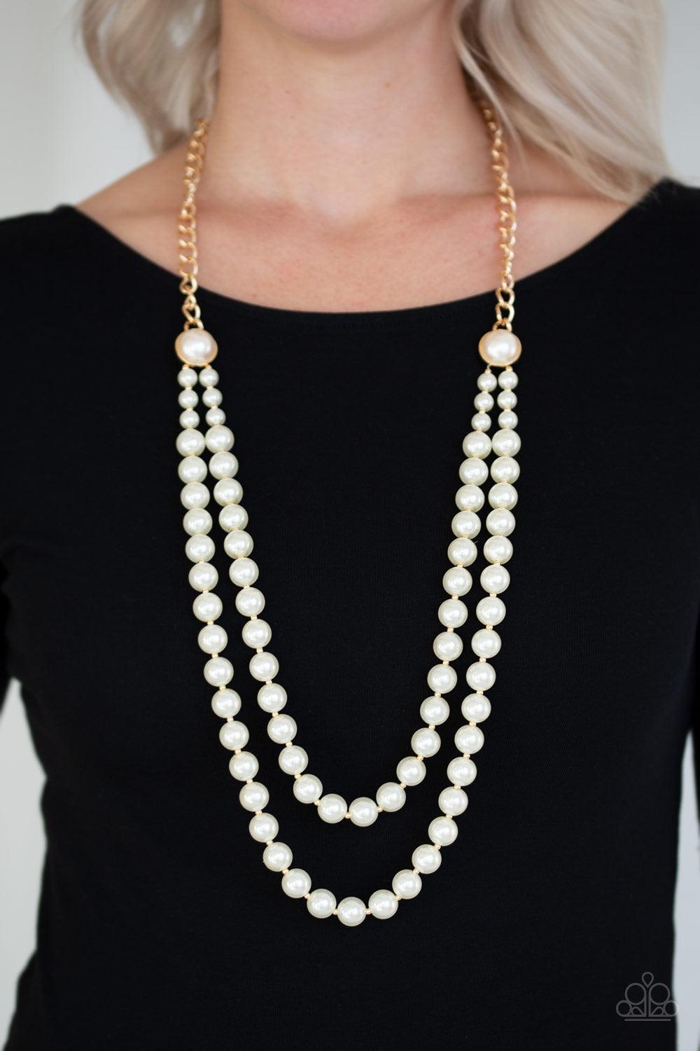 Paparazzi Accessories Endless Elegance - Gold A dramatic gold chain gives way to two strands of pearly white beads. Infused with matching pearl fittings and dainty gold accents, the beaded strand drapes down the chest in a refined fashion. Features an adj