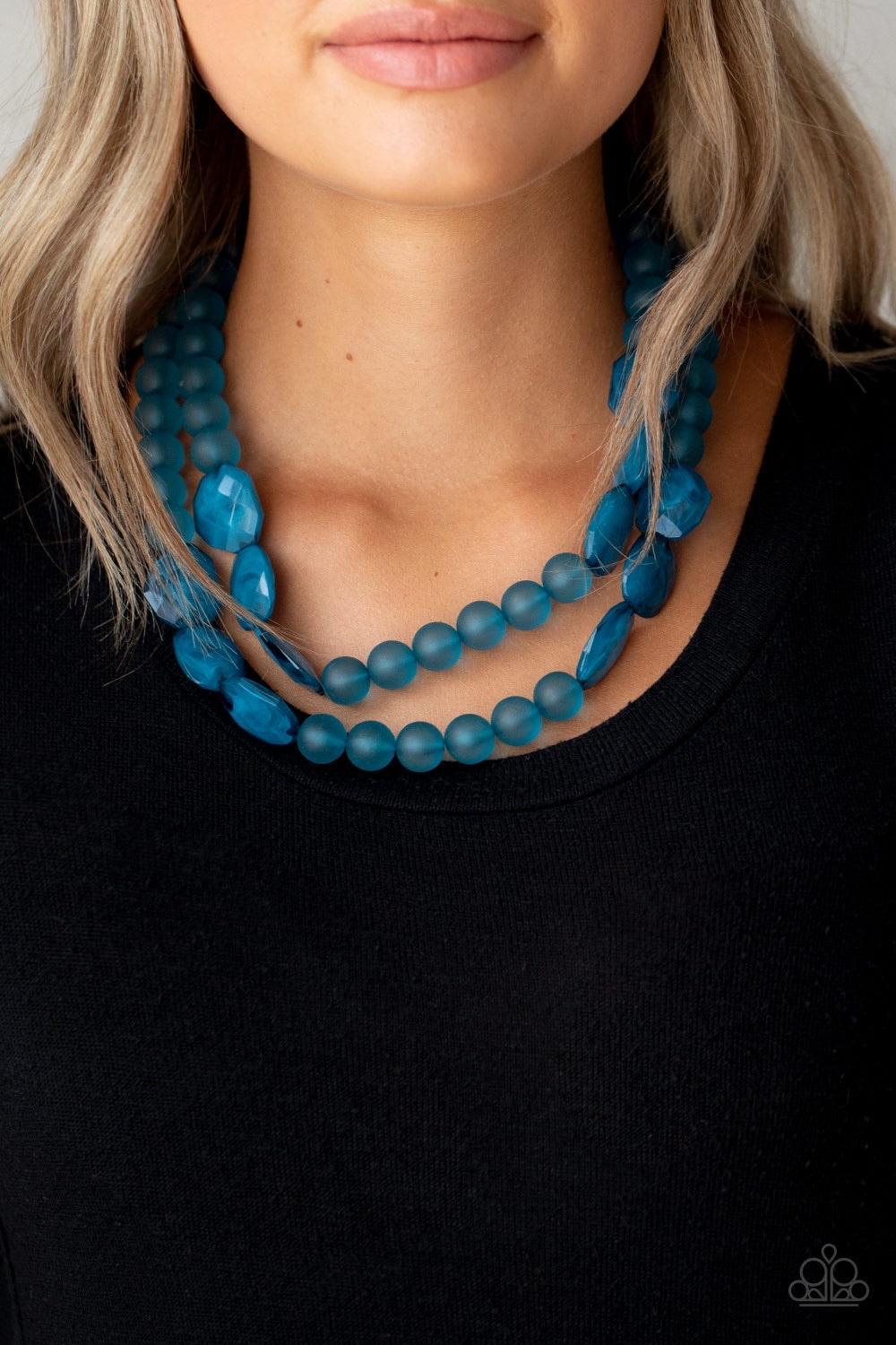 Paparazzi Accessories Arctic Art - Blue Featuring round and imperfectly flat shapes, an icy compilation of opaque Mosaic Blue beads are threaded along invisible wires, creating colorfully glassy layers below the collar. Features an adjustable clasp closur