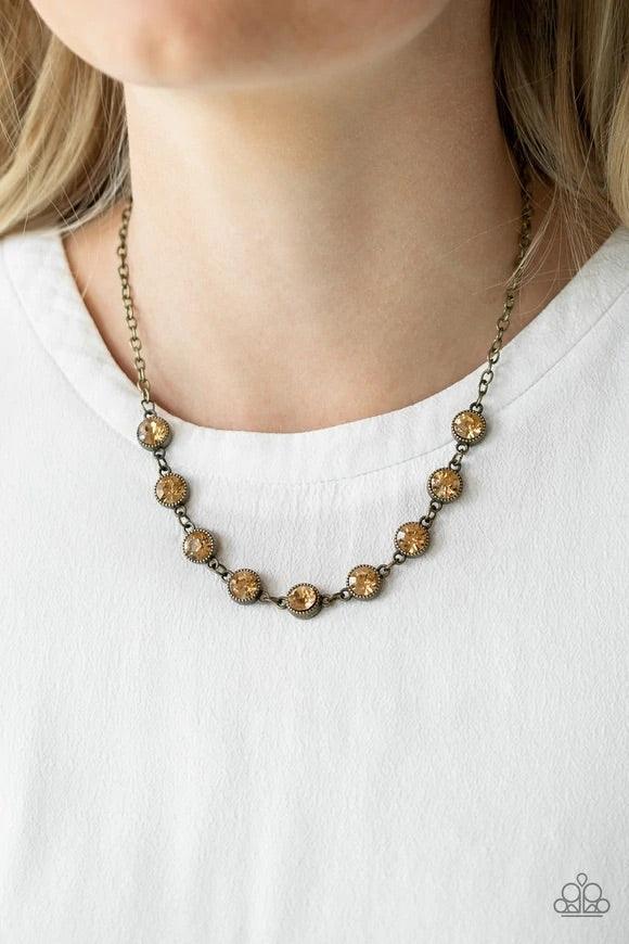 Paparazzi Accessories Starlit Socials - Brass Encased in studded brass frames, golden topaz rhinestones link below the collar for a glamorous look. Features an adjustable clasp closure. Sold as one individual necklace. Includes one pair of matching earrin