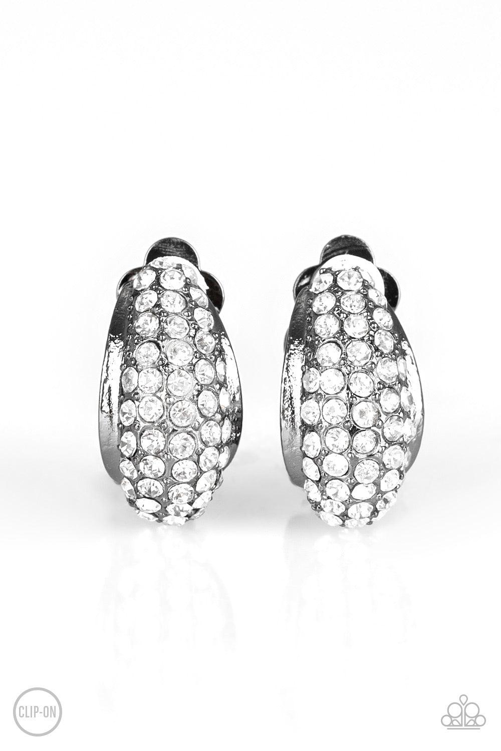 Paparazzi Accessories Revenue Avenue - Black *Clip-On A glistening gunmetal frame is encrusted in row after row of glassy white rhinestones for a timeless look. Earring attaches to a standard clip-on fitting. Jewelry