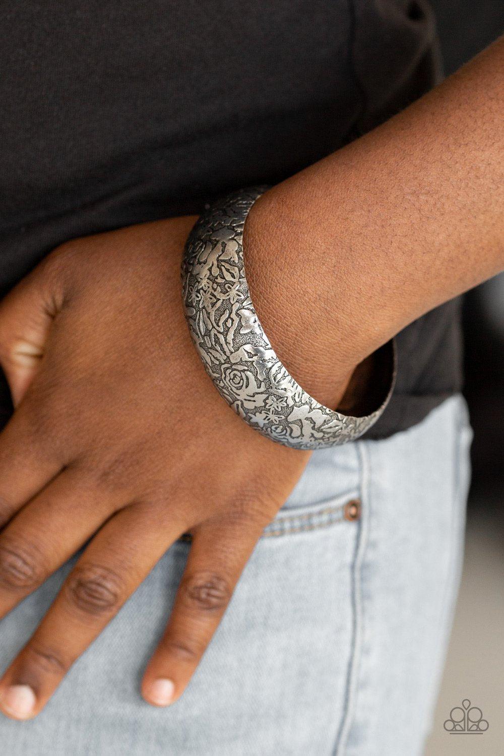 Paparazzi Accessories Garden Villa - Silver Brushed in an antiqued finish, a rosy floral pattern is embossed across a thick silver bangle for a seasonal flair. Sold as one individual bracelet. Jewelry