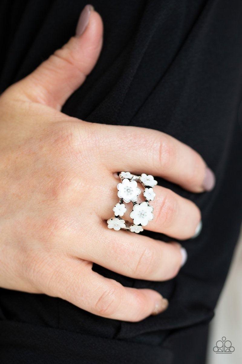 Paparazzi Accessories Floral Crowns - White A collection of shiny white flowers delicately connect across the finger, creating a colorful layered look for a seasonal flair. Features a dainty stretchy band for a flexible fit. Jewelry