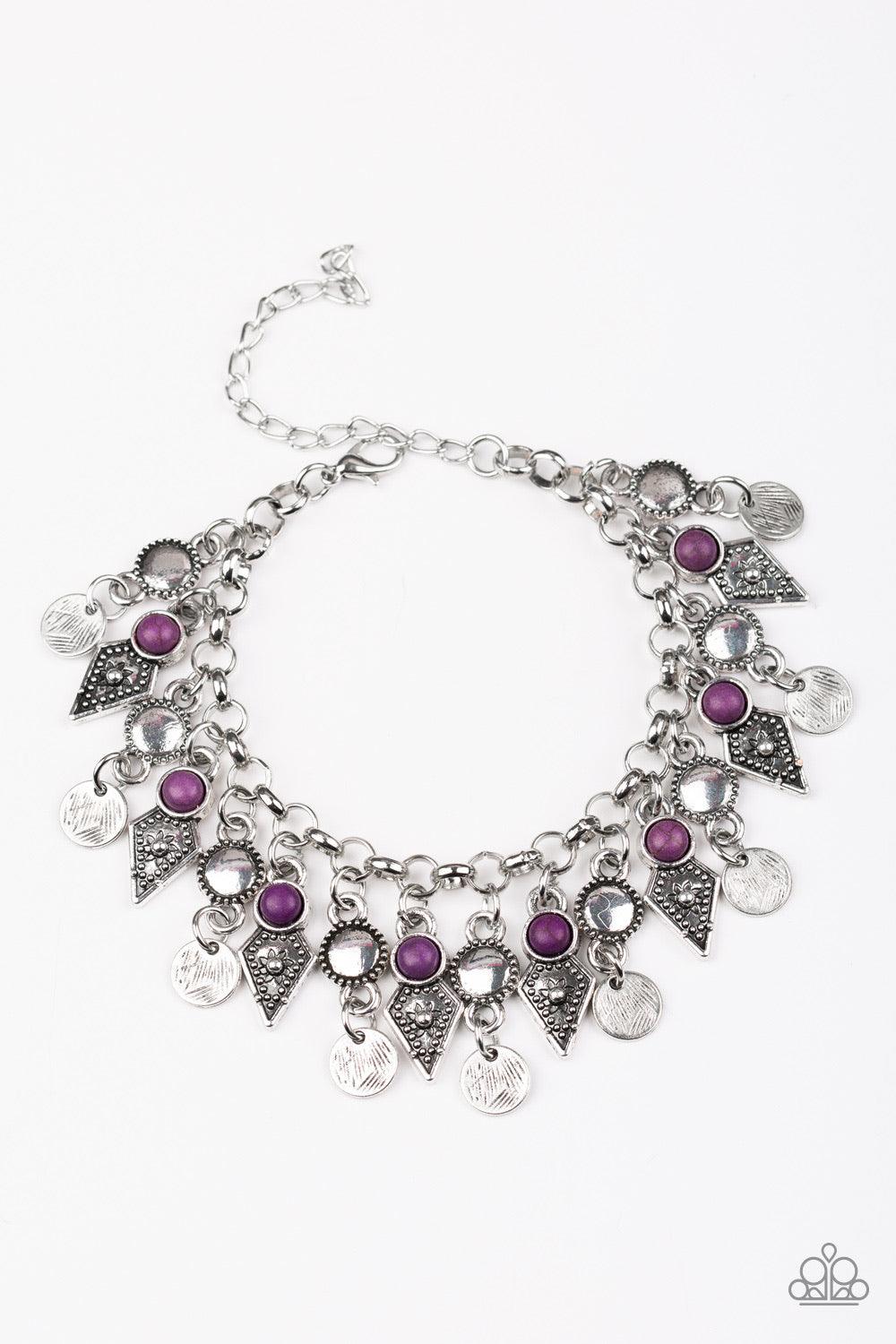 Paparazzi Accessories Triassic Trade Route ~Purple Featuring studded detail and vivacious purple stone accents, mismatched silver frames swing from the bottom of a bold silver chain, creating a flirty fringe around the wrist. Features an adjustable clasp