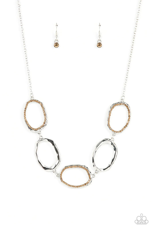 Paparazzi Accessories Grit Go-Getter - Brown A row of dazzling light topaz rhinestones makes its way around a delicately hammered imperfect circular frame. The airy frames alternately link end to end with similar shiny silver frames creating a glitzy fash