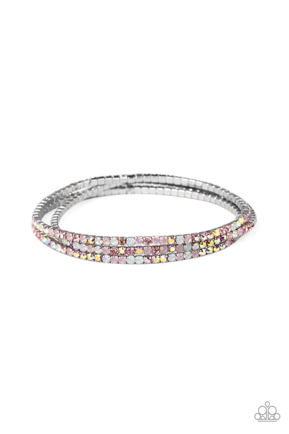 Paparazzi Accessories Sugar and Ice - Pink Featuring classic and opalescent finishes, a collection of dainty pink and white rhinestones are threaded along stretchy bands, creating glittery layers across the wrist. Jewelry