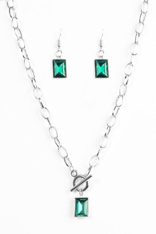 Paparazzi Accessories Wear it Like You Mean It! - Green Featuring a regal emerald-style cut, a glassy green rhinestone is pressed into a sleek silver frame. The glittery frame swings from the bottom of a bold silver chain, creating a glamorous pendant bel