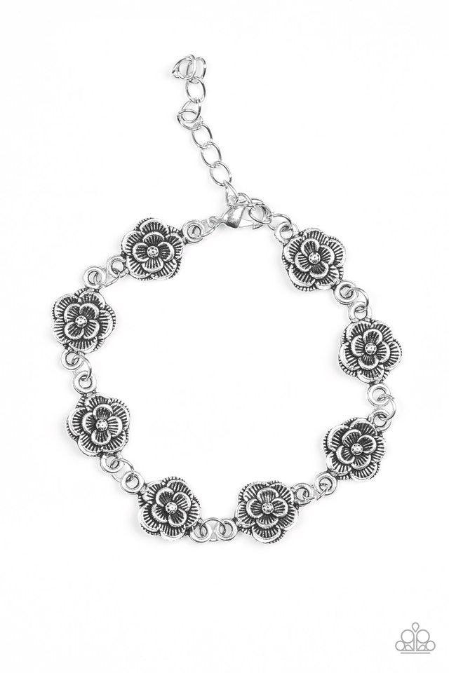 Paparazzi Accessories Wildflower Wonderland - Silver Brushed in an antiqued shimmer, dainty silver blossoms link across the wrist for a whimsical fashion. Features an adjustable clasp closure. Jewelry
