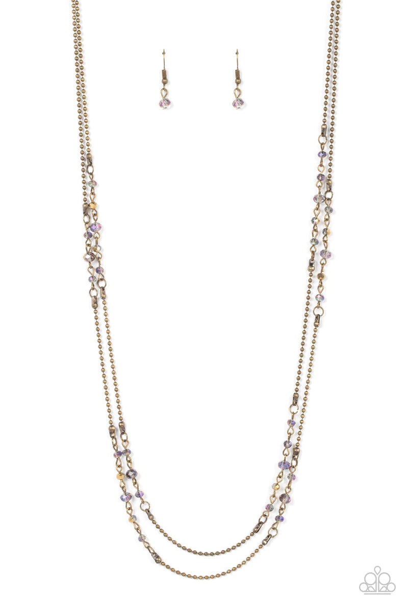Paparazzi Accessories Petitely Prismatic - Brass Sections of aurum and iridescent crystal-like beads embellish strands of dainty brass beaded chains, resulting in prismatic layers across the chest. Features an adjustable clasp closure. Sold as one individ