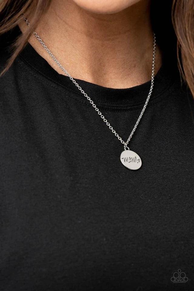 Paparazzi Accessories The Cool Mom - Silver A dainty heart engraved next to the word "Mom" on a shiny silver disc creates a sweet memento as it falls below the collar. Features an adjustable clasp closure. Jewelry