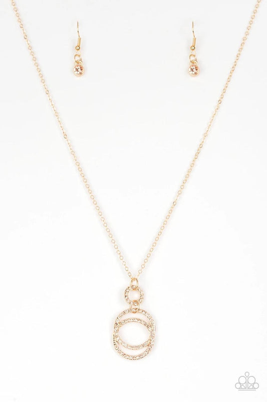 Paparazzi Accessories Timeless Trio - Gold Encrusted in radiant peach rhinestones, three gold hoops interlock at the bottom of an elongated gold chain for an elegant look. Features an adjustable clasp closure. Sold as one individual necklace. Includes one