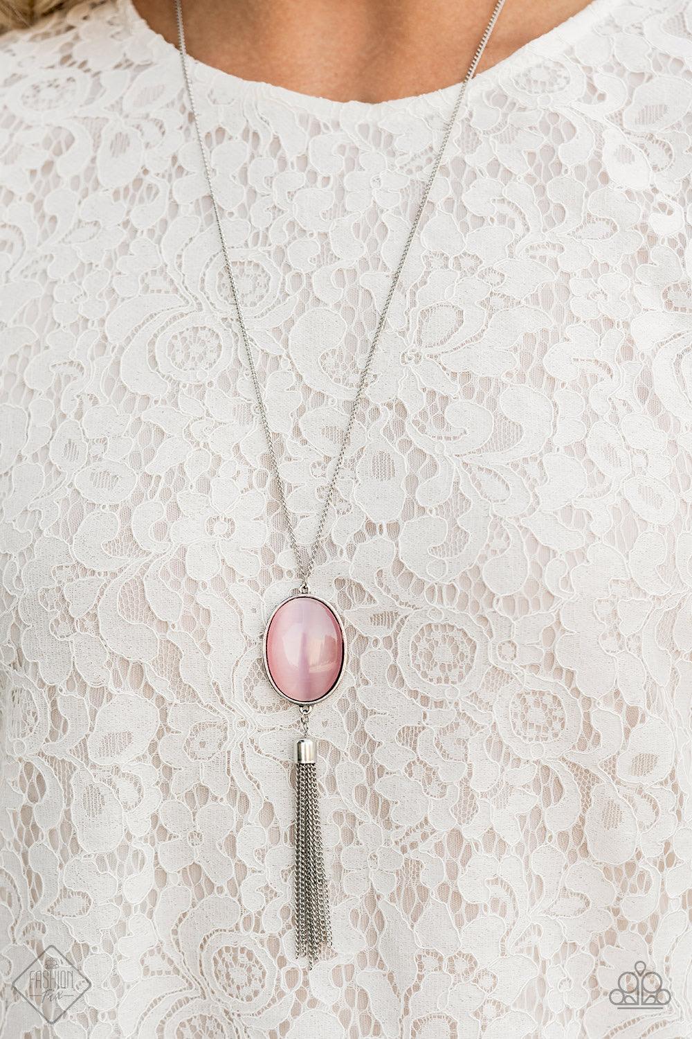 Paparazzi Accessories Tasseled Tranquility - Pink An oversized pink cat's eye stone frame gives way to a shimmery silver chain tassel, creating a whimsically stacked pendant at the bottom of a lengthened silver chain. Features an adjustable clasp closure.