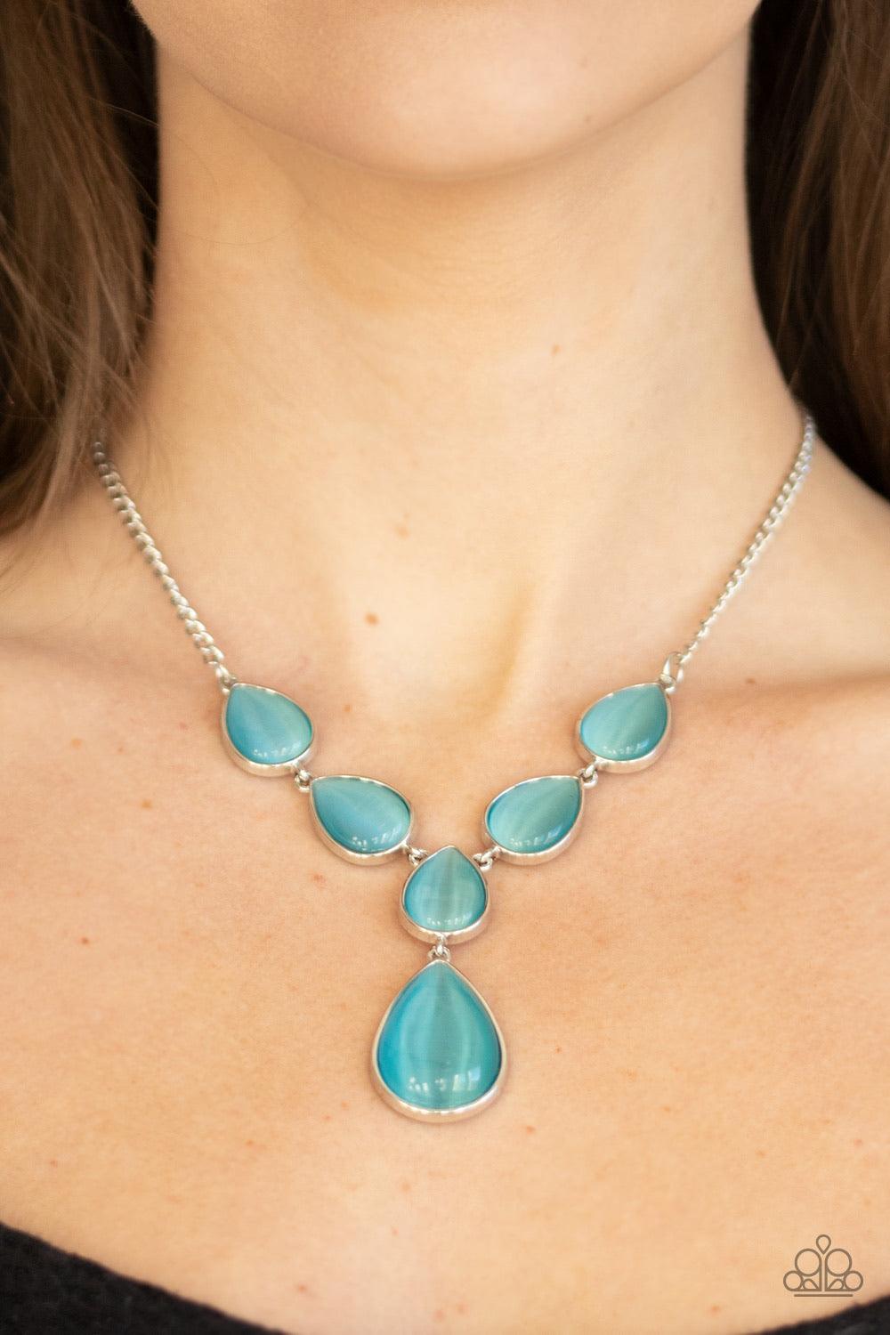 Paparazzi Accessories Dewy Decadence - Blue A series of blue cat's eye teardrops interlock at the bottom of a silver chain, giving way to an oversized teardrop pendant for a refined finish. Features an adjustable clasp closure. Jewelry