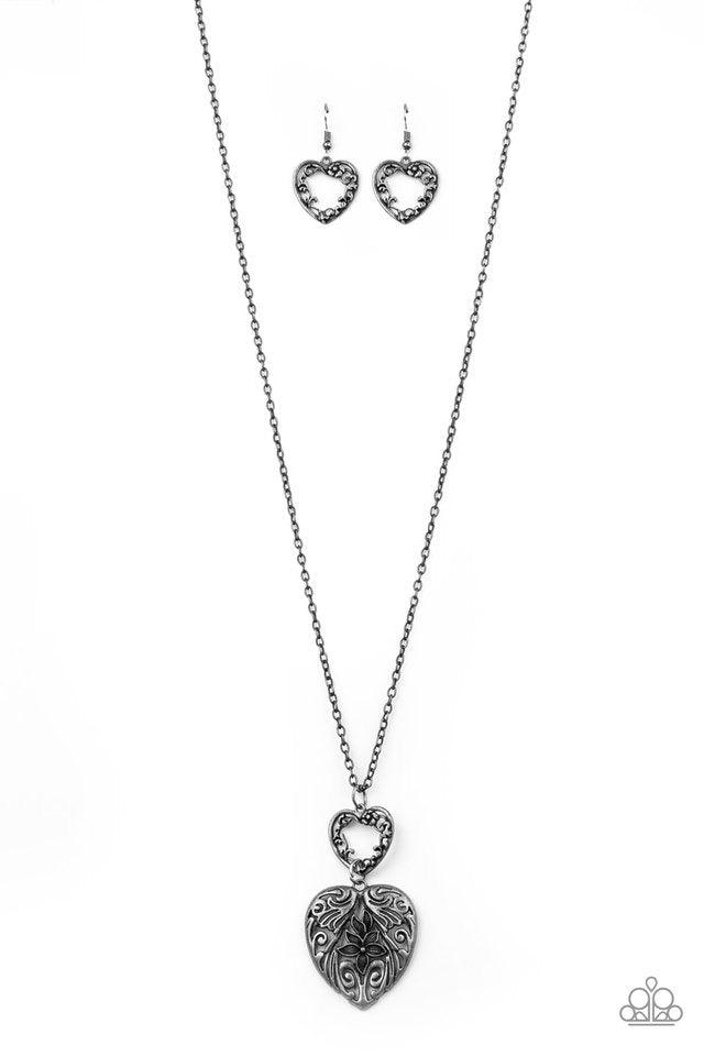 Paparazzi Accessories Garden Lovers - Silver Swirling with ornate floral filigree details, a pair of tin finished silver heart frames link at the bottom of a lengthened silver chain for a vintage inspired look. Features an adjustable clasp closure. Sold a