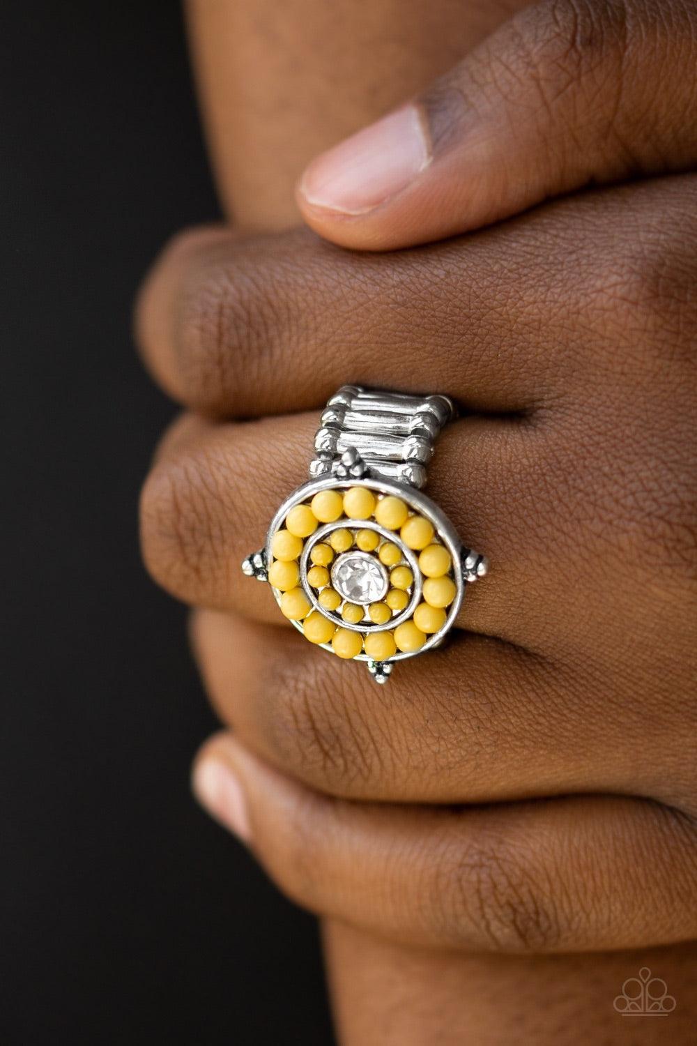 Paparazzi Accessories Hide Tide Pool Party - Yellow Vivacious yellow beads spin around a glittery white rhinestone center, creating a bright and summery centerpiece atop the finger. Features a stretchy band for a flexible fit. Jewelry