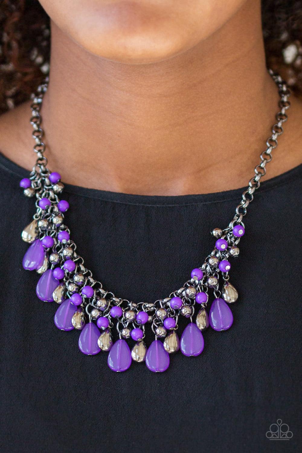 Paparazzi Accessories Diva Attitude - Purple Glistening gunmetal and vivacious purple teardrops drip from the bottom of interlocking gunmetal chains. Matching gunmetal and purple beads trickle down the rows of chain, creating a bold fringe below the colla