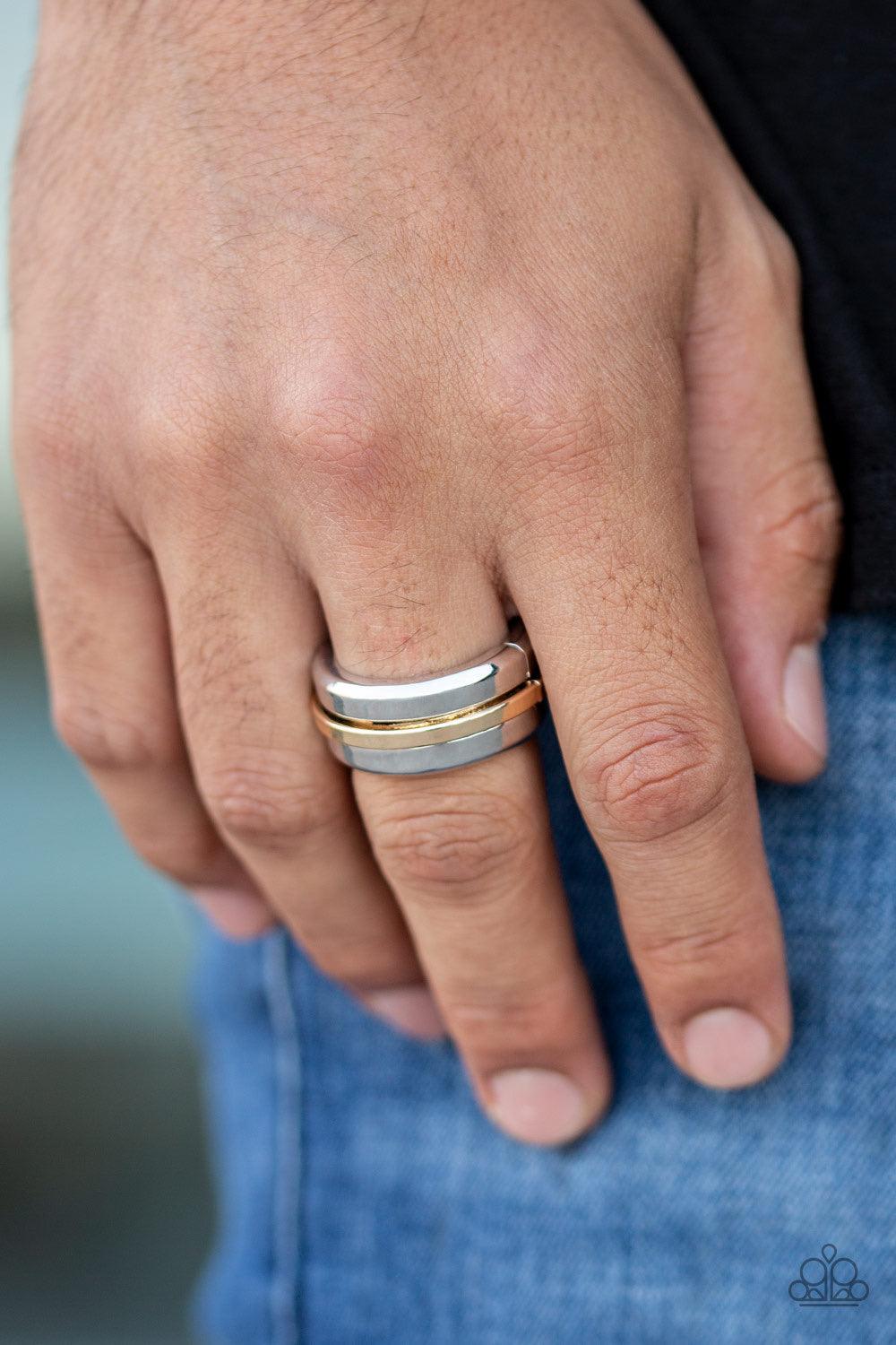 Paparazzi Accessories Battle Tank - Silver A glistening gold bar arcs across the center of thick silver band for a modern look. Features a stretchy band for a flexible fit. Jewelry