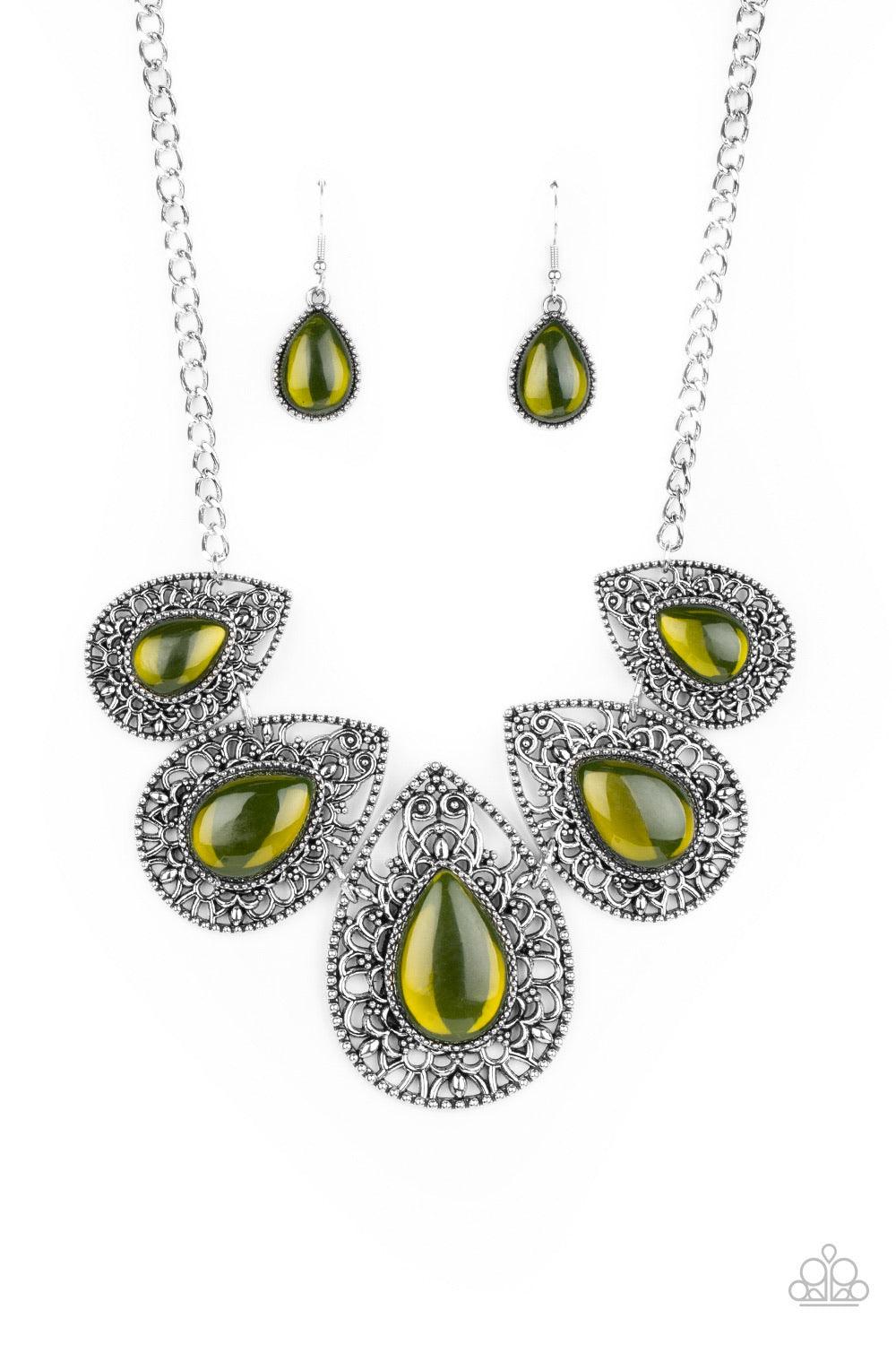 Paparazzi Accessories Opal Auras - Green Featuring an opalescent shimmer, glassy Military Olive teardrop beads are nestled inside shiny silver frames filled with vine-like antiqued filigree. Graduating in size, the whimsical frames delicately link below t