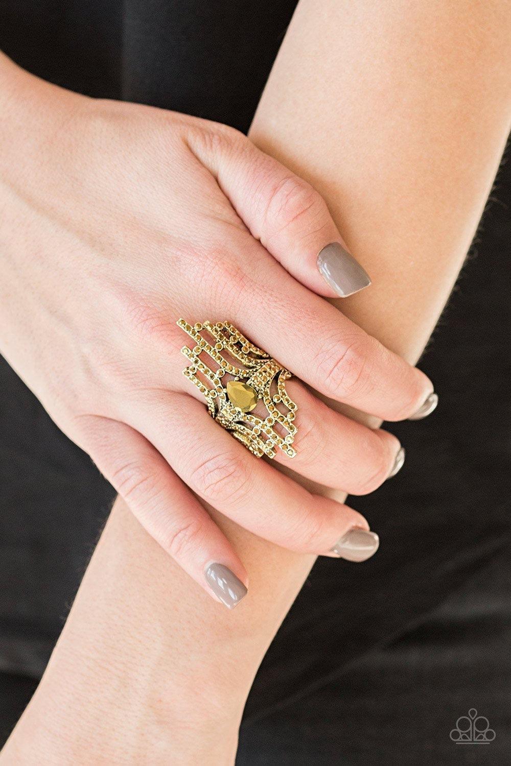 Paparazzi Accessories Modern Muse - Brass Encrusted with glittery aurum rhinestones, a collection of brass bars radiate from a teardrop aurum rhinestone center for an edgy stacked look. Features a stretchy band for a flexible fit. Jewelry