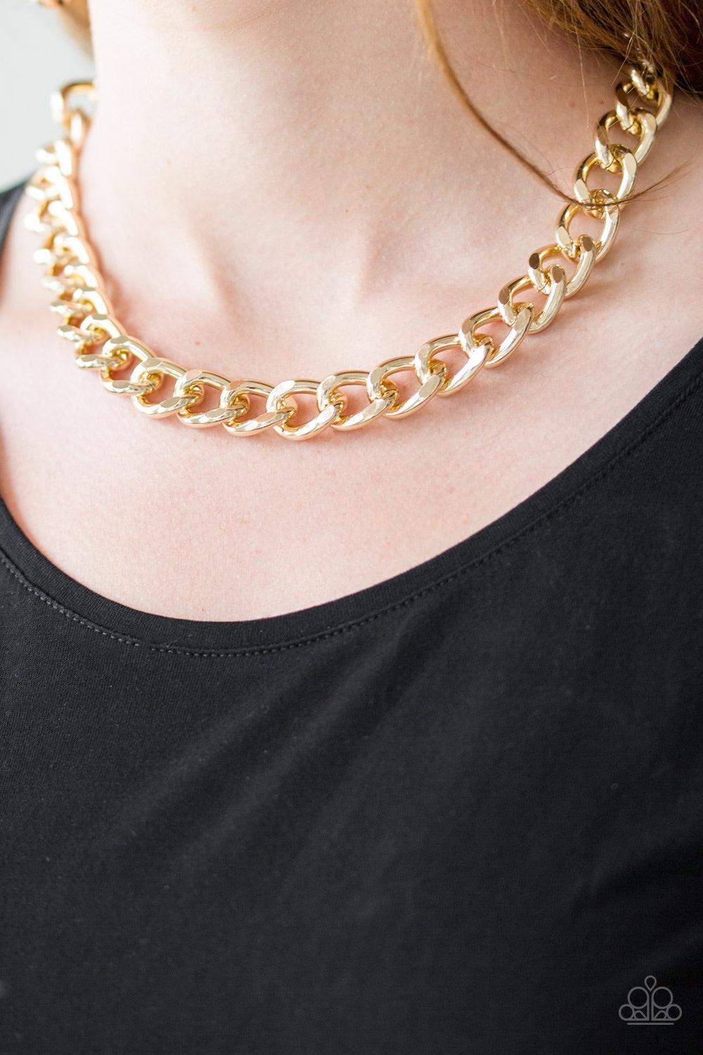 Paparazzi Accessories Heavyweight Champion - Gold Brushed in a high-sheen shimmer, a bold gold chain drapes below the collar in an edgy industrial fashion. Features an adjustable clasp closure. Jewelry