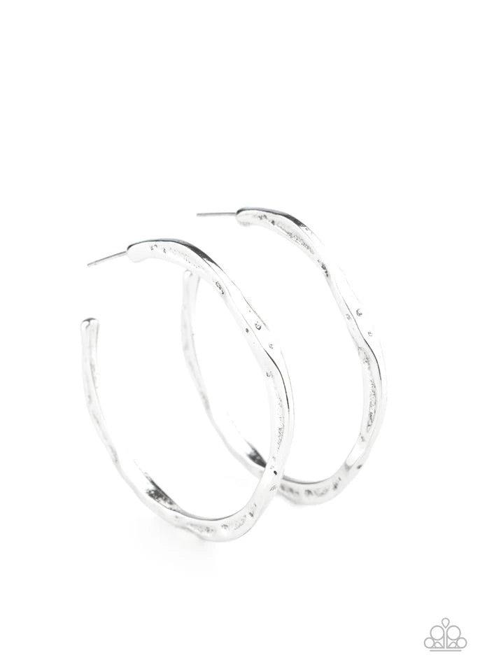 Paparazzi Accessories Asymmetrical Attitude - Silver Delicately hammered in shimmery textures, a flat silver bar curls into an asymmetrical hoop for a trendy vibe. Hoop measures approximately 1 1/2" in diameter. Jewelry