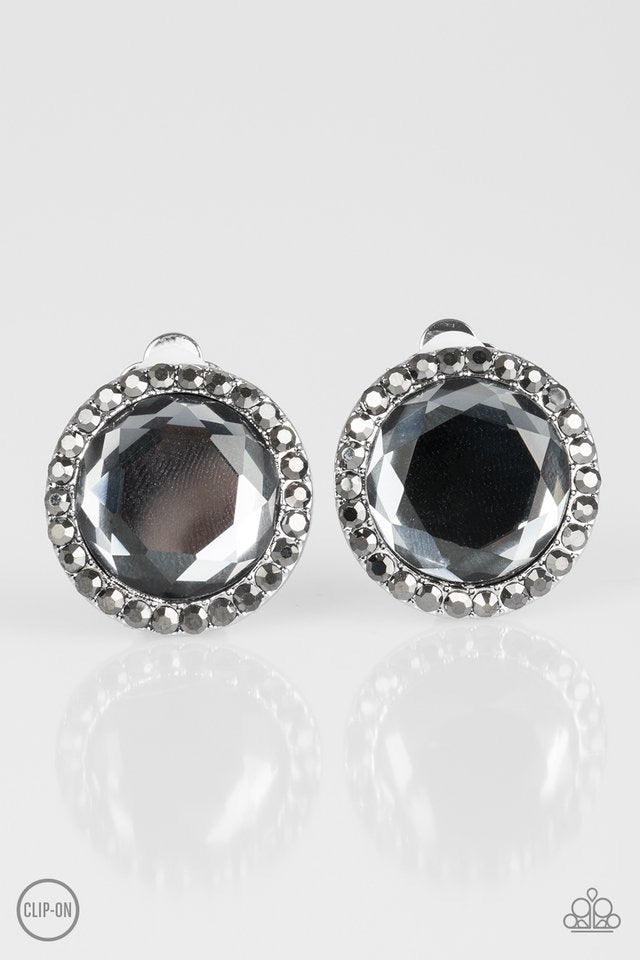 Paparazzi Accessories Positively Princess - Silver *Clip-On A smoky gem is pressed into the center of a hematite rhinestone encrusted frame for a timeless look. Earring attaches to a standard clip-on fitting. Jewelry