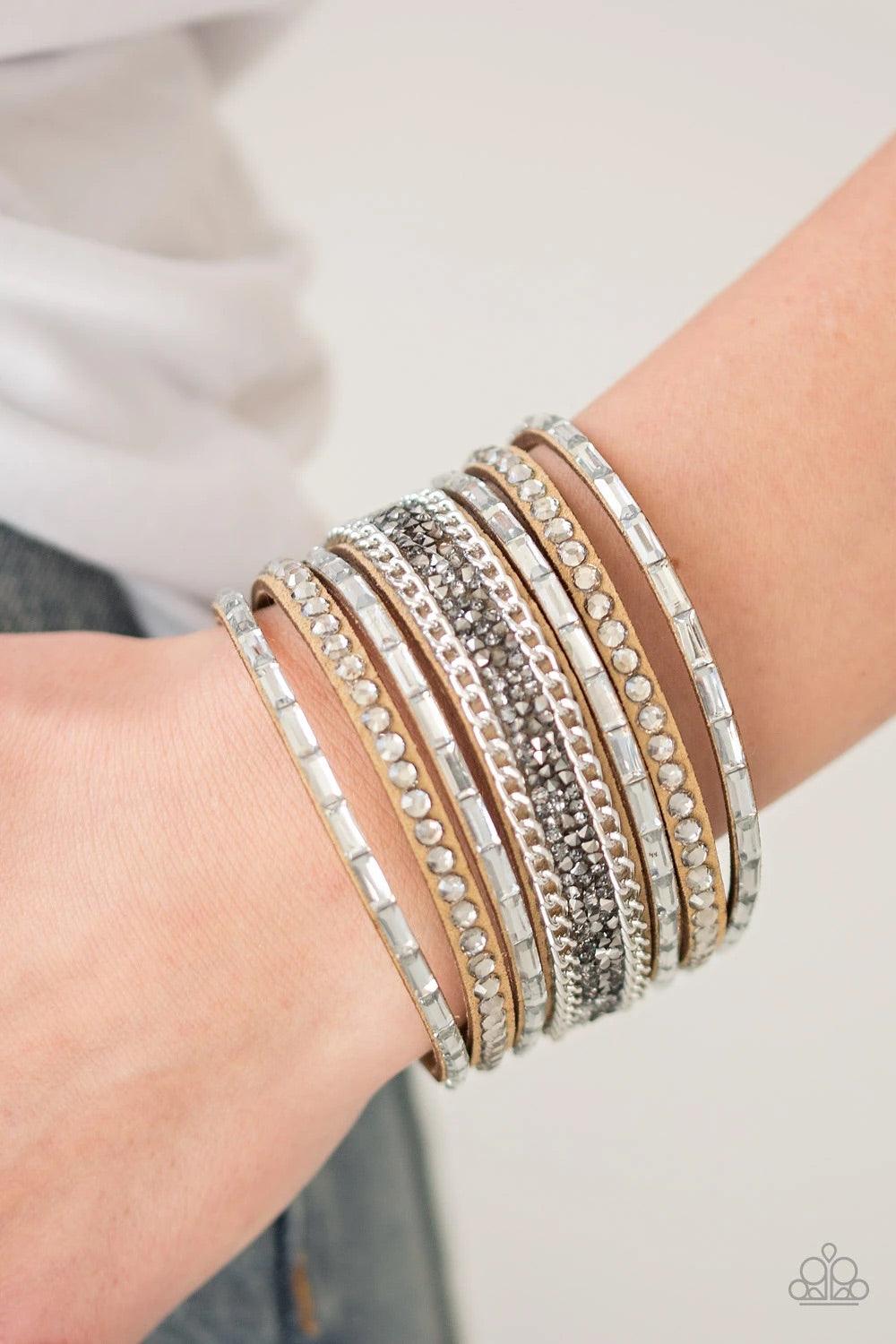 Paparazzi Accessories Rhinestone Rumble - Brown White emerald-cut rhinestones, smoky round rhinestones, and metallic prism-shaped rhinestones are sprinkled along strands of brown suede. Shimmery silver chain is added to the mix for a sassy industrial fini