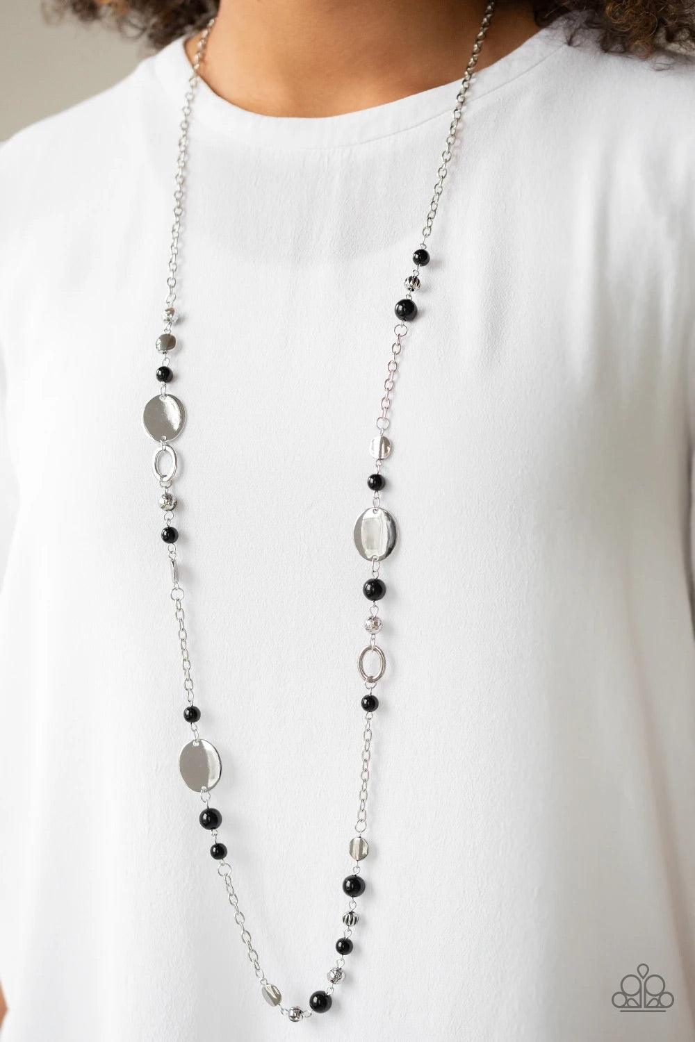 Paparazzi Accessories Serenely Springtime - Black An array of polished black beads, silver discs, and ornate silver accents trickles along a shimmery silver chain for a whimsical look. Features an adjustable clasp closure. Sold as one individual necklace.