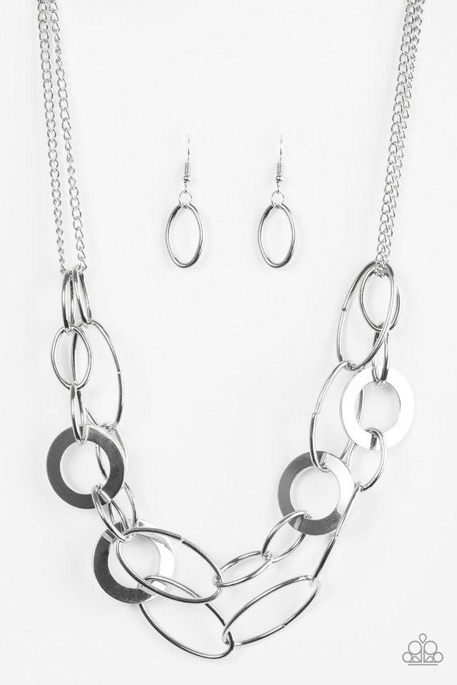 Paparazzi Accessories Metallic Maverick - Silver Mismatched silver rings and hoops link below the collar in bold layers for a spunky industrial look. Features an adjustable clasp closure. Sold as one individual necklace. Includes one pair of matching earr