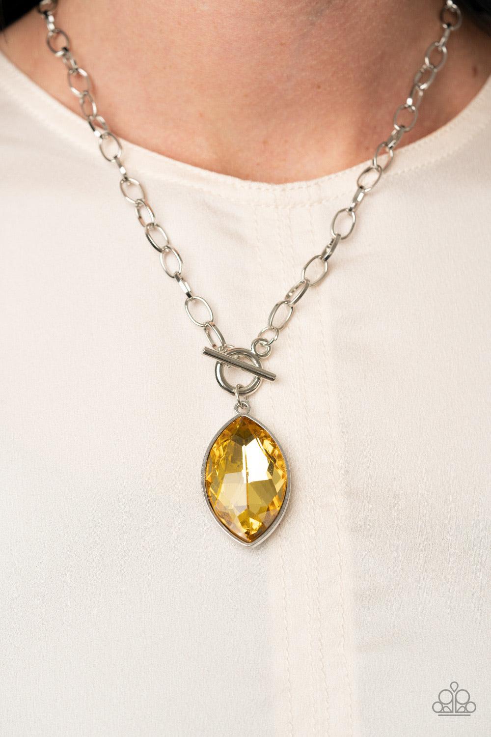 Paparazzi Accessories Unlimited Sparkle - Yellow Featuring a regal marquise style cut, a dramatically oversized golden yellow rhinestone swings from a chunky silver chain, creating a gorgeous pendant below the collar. Features a toggle closure. Sold as on