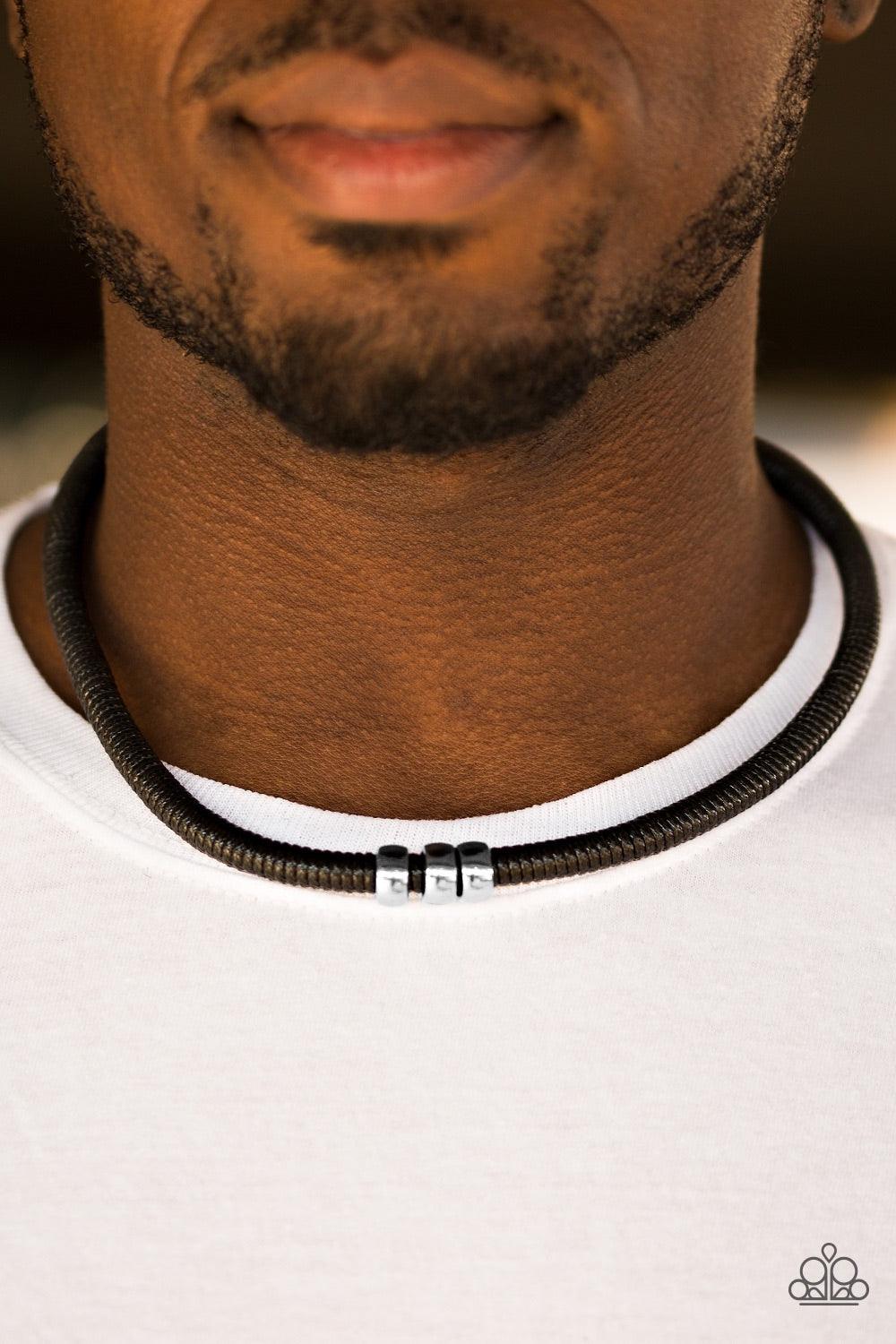 Paparazzi Accessories Trail Rules - Black Shiny black twine wraps around a black cord, creating an urban look below the collar. Shiny silver beads slide along the cording for a rugged finish. Features a button loop closure. Jewelry