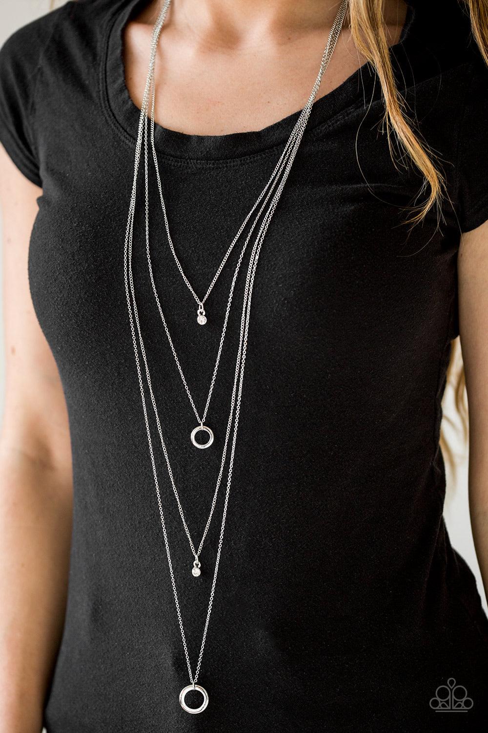 Paparazzi Accessories All About Elegance - White Glittery white rhinestones alternate with glistening silver hoops down the chest, creating refined layers. Features an adjustable clasp closure. Sold as one individual necklace. Includes one pair of matchin