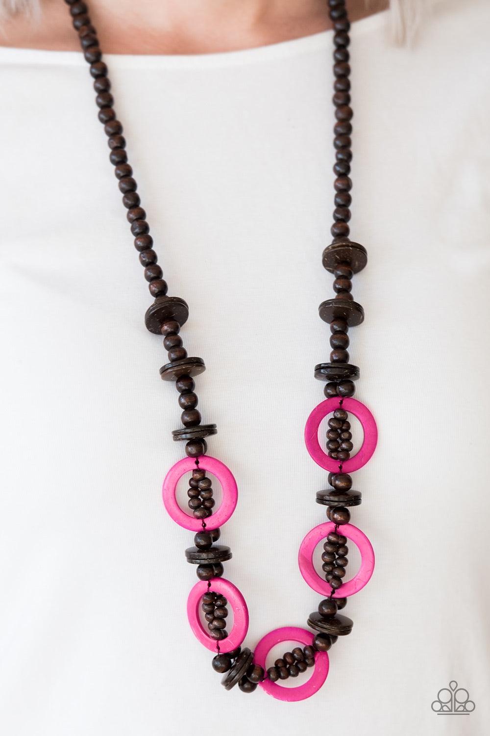 Paparazzi Accessories Fiji Foxtrot - Pink Mismatched brown wooden beads are threaded along a brown cord for an earthy look. Vivacious pink wooden discs connect with beaded links across the chest for a summery finish. Jewelry