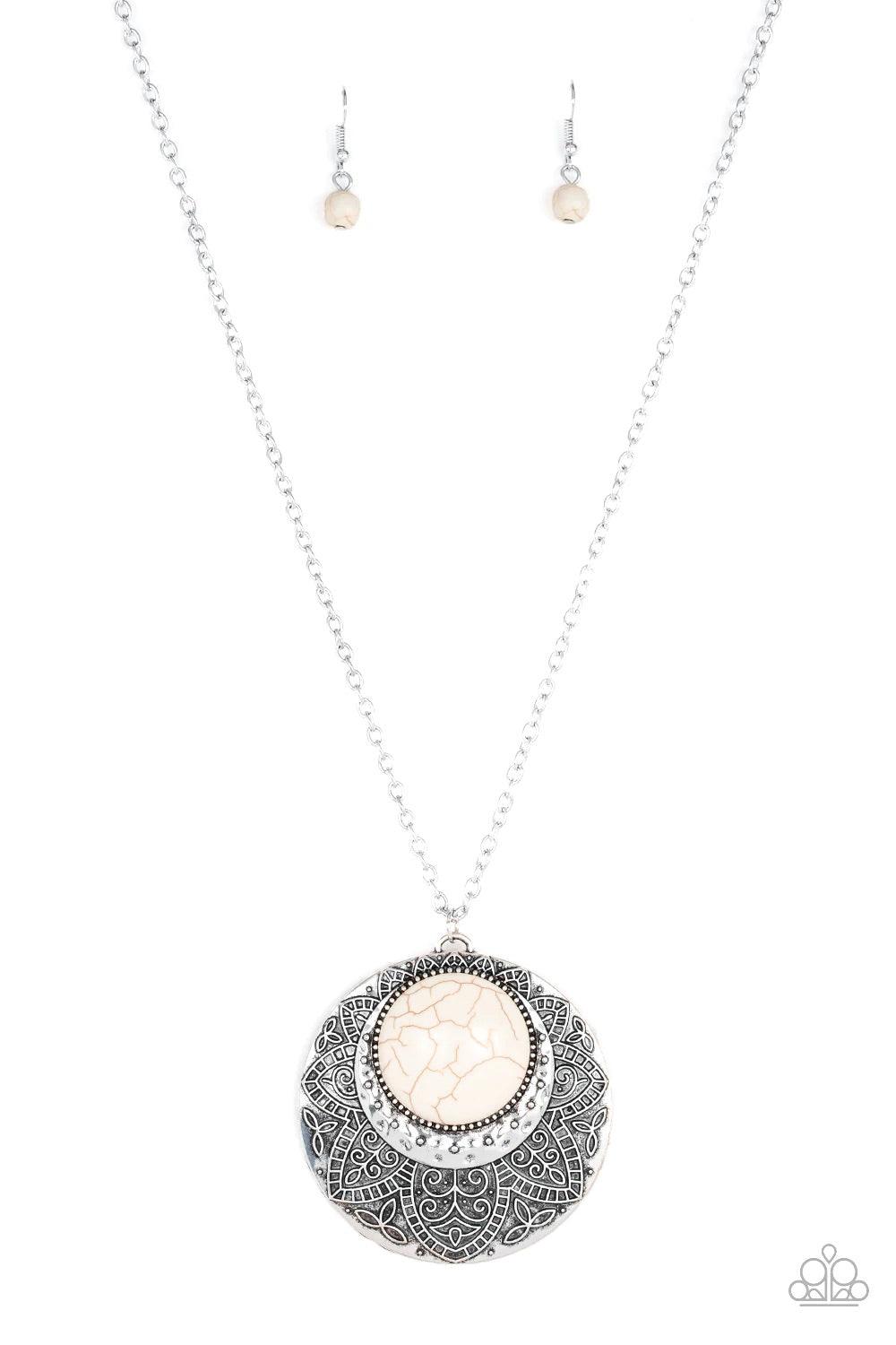 Paparazzi Accessories Medallion Meadow - White Swinging from the bottom of a lengthened silver chain, a refreshing white stone is pressed into a hammered silver medallion radiating with floral details for a bold tribal inspired look. Features an adjustabl