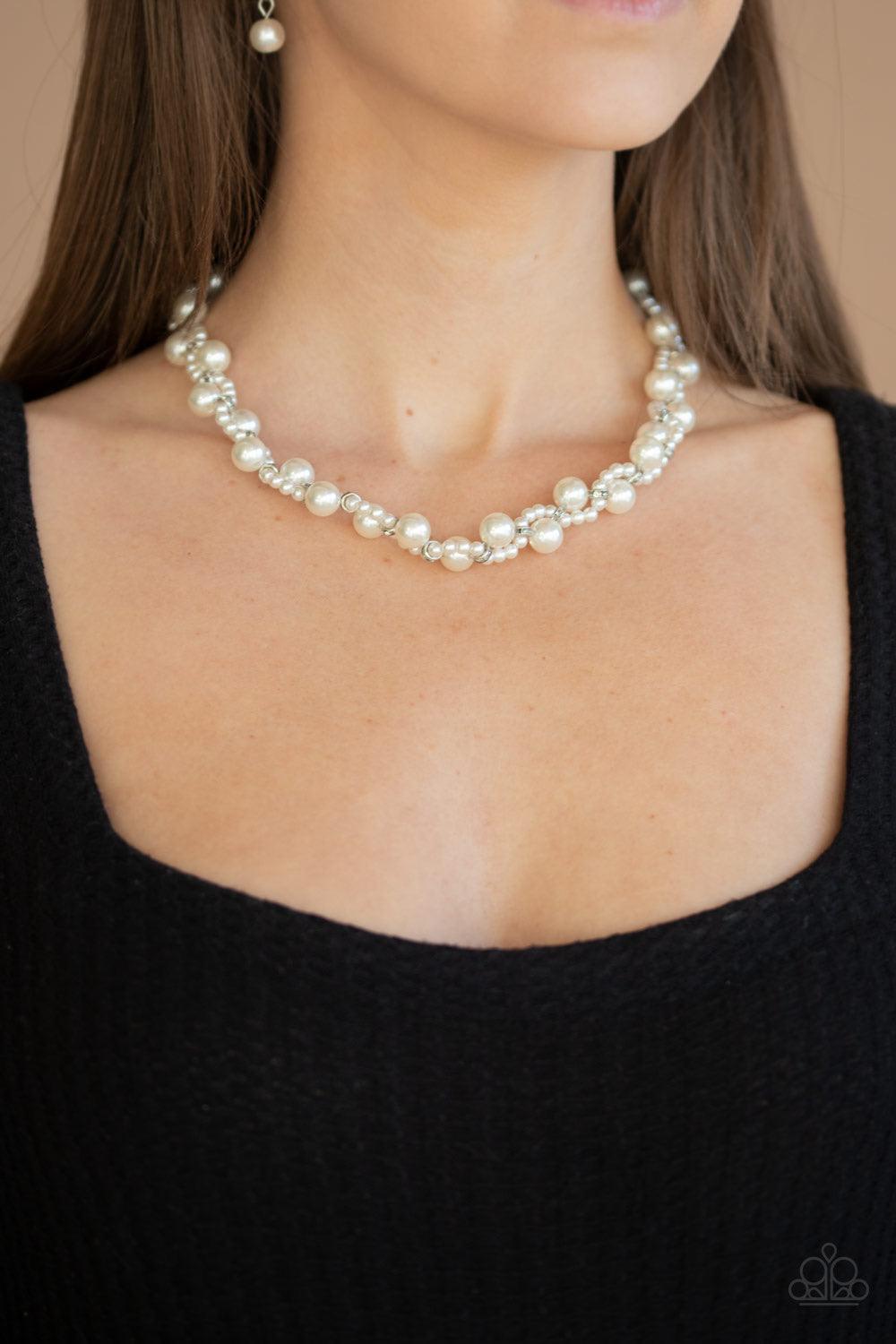 Paparazzi Accessories Uptown Opulence ~White Threaded along invisible wires, a strand of classic white pearls delicately weaves with a strand of dainty white pearls and white rhinestone encrusted rings below the collar for a timeless twist. Features an ad
